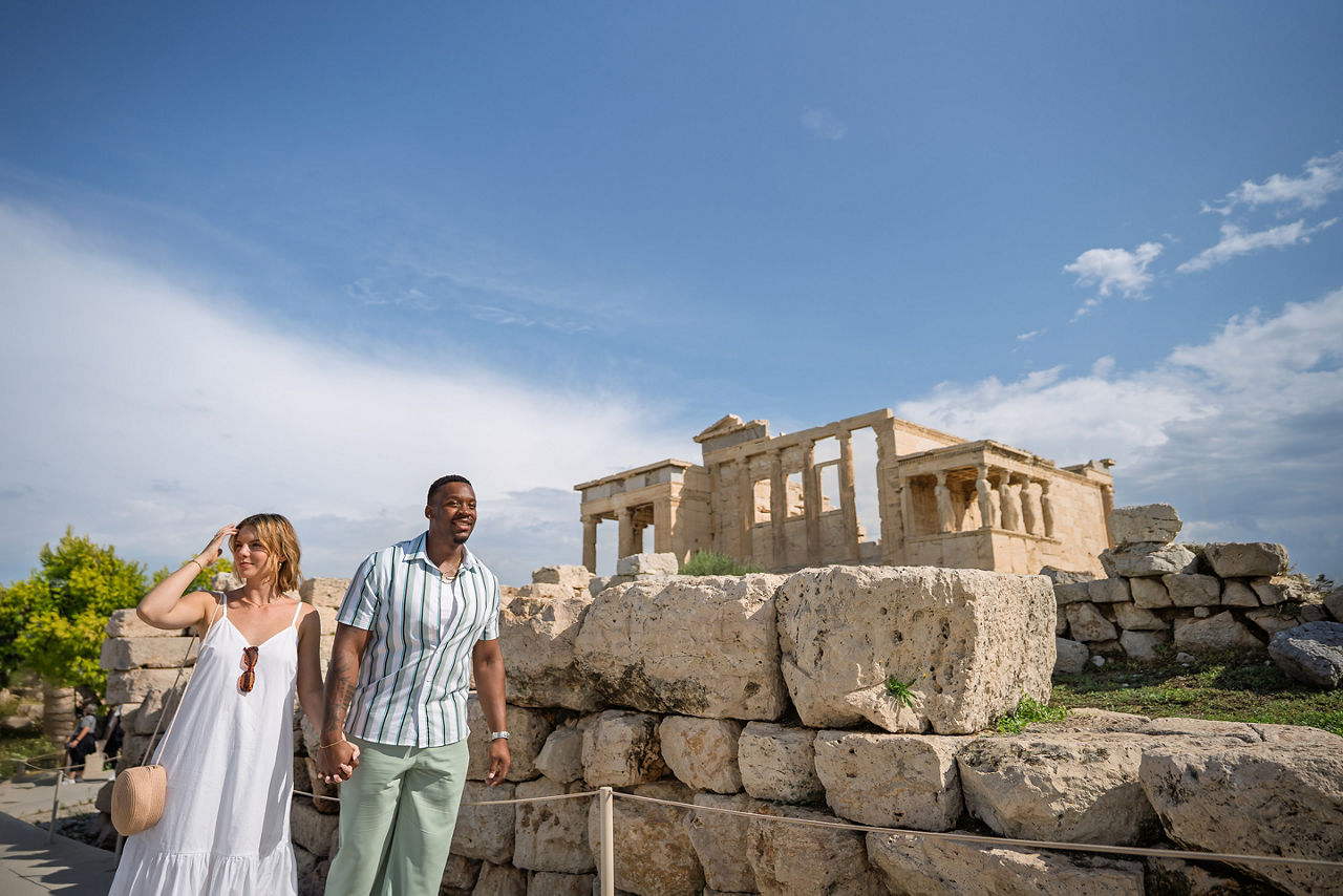 Couple holding hands while walking in Erechtheion, Athens, Greece