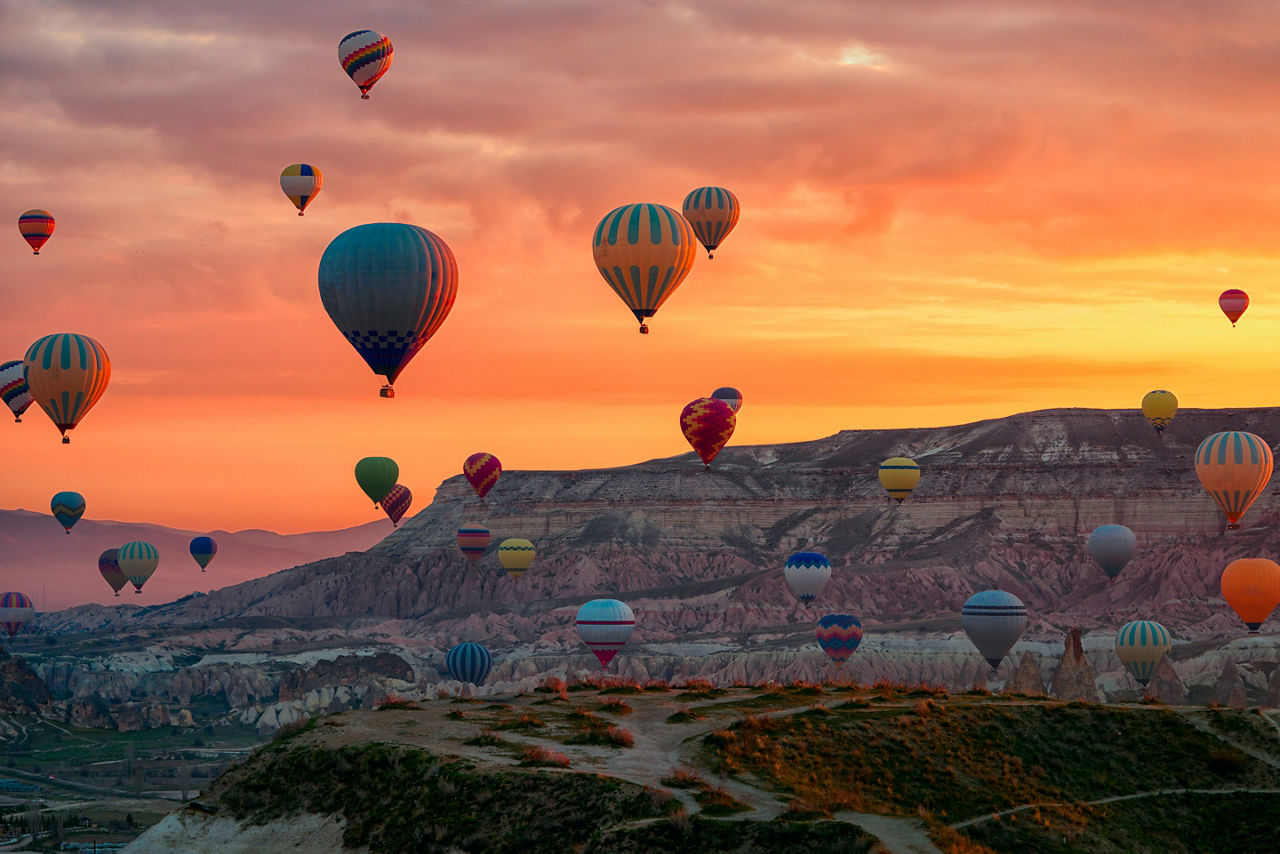 Hot air balloon riding tours flying over Goreme National Park. Cappadocia, Turkey.