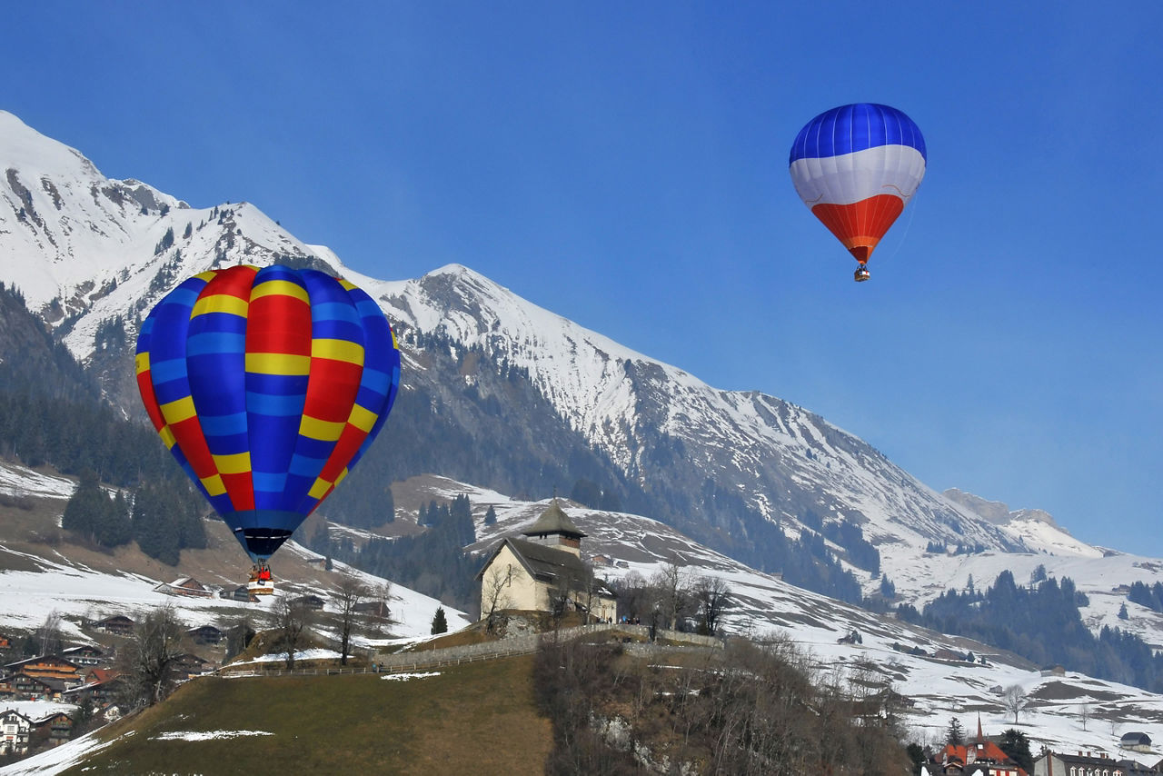 hot air balloons over the swiss alps