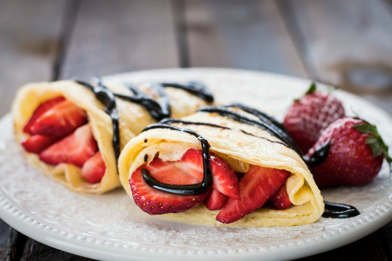 Frashly baked pancakes with strawberries and chocolate sauce