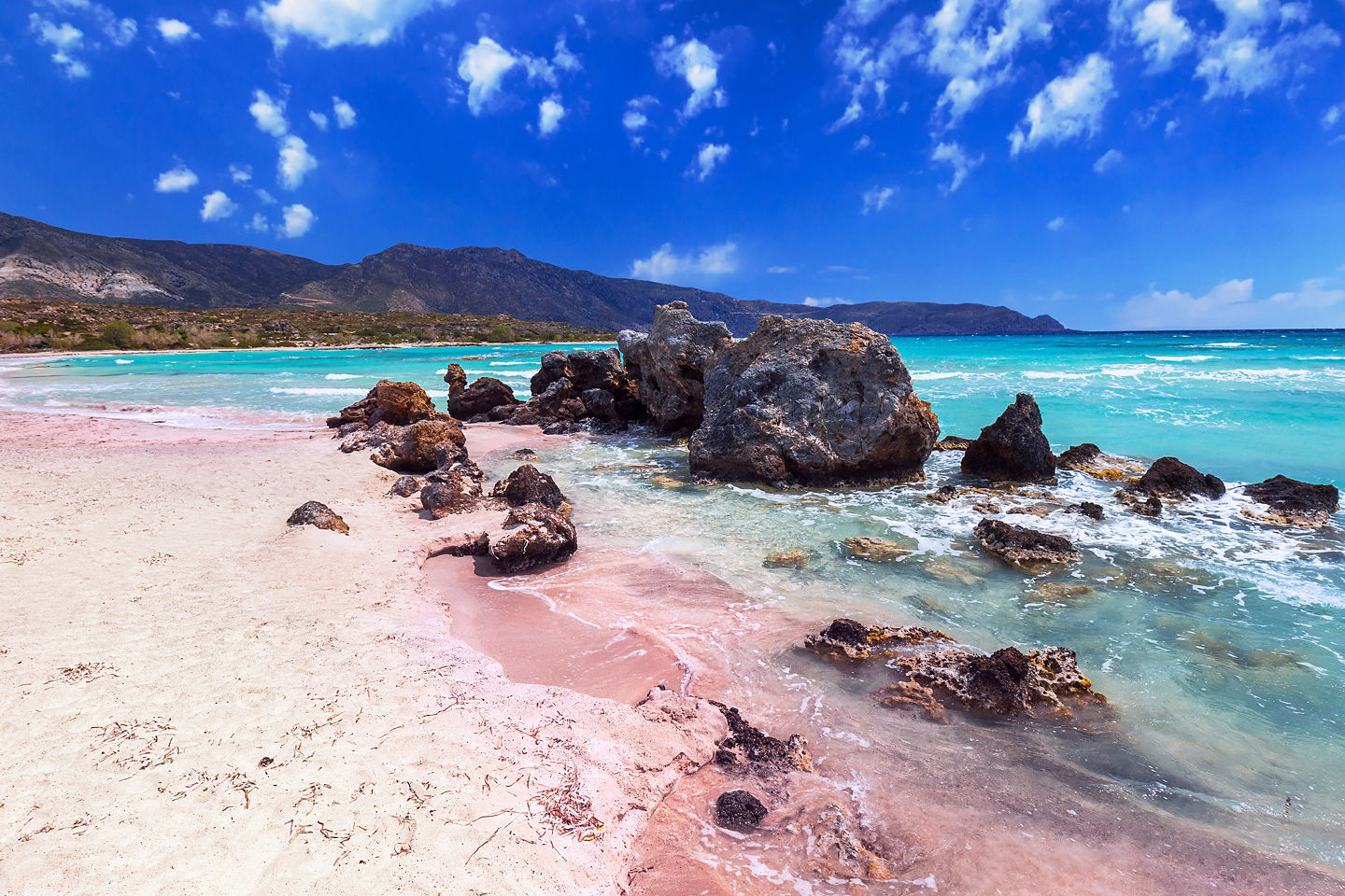 Soft pink sands of Elafonissi Beach meets clear turquoise water under Greece’s bright summer sun. - Chania, Crete