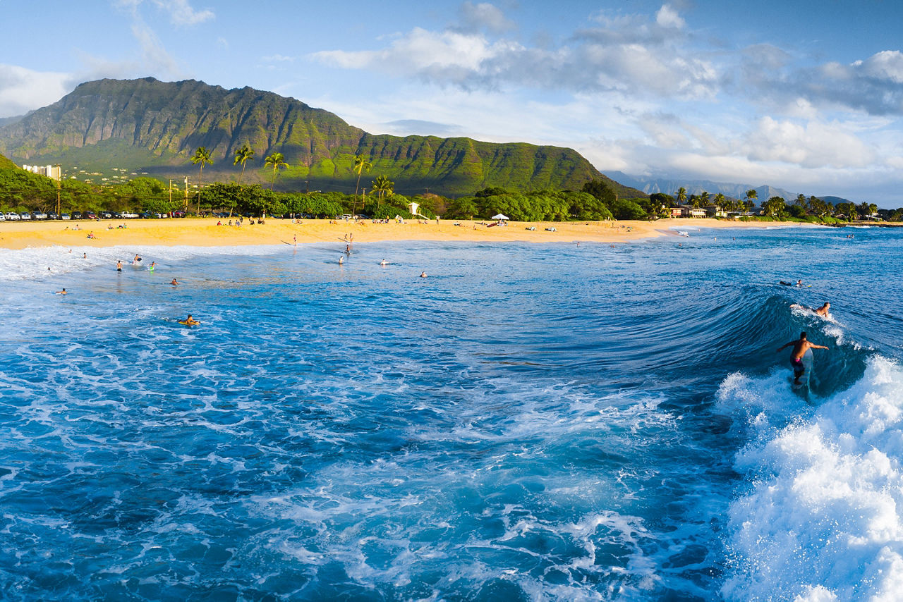 Panorama of the surf spot Makaha with the surfer riding the wave Oahu Hawaii