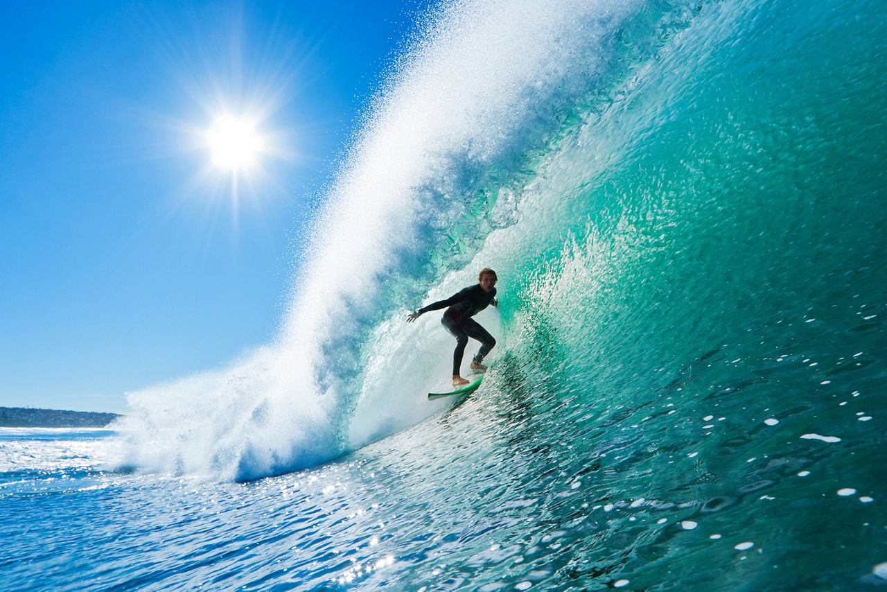 Surfer on Amazing Blue Wave in the Epic Barrel Tube Hawaii