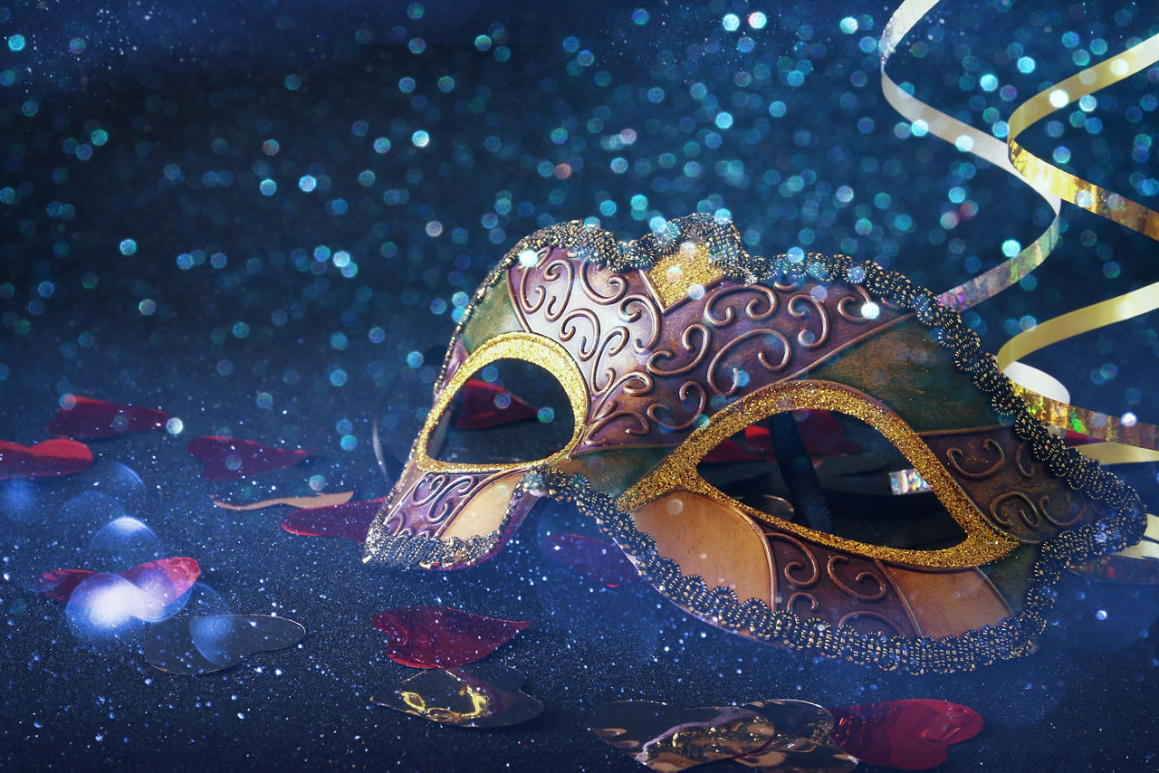 Mardi gras mask on glitter background. Italy.