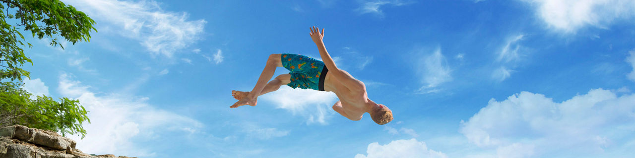 Man Jumping into Ocean in Jamaica