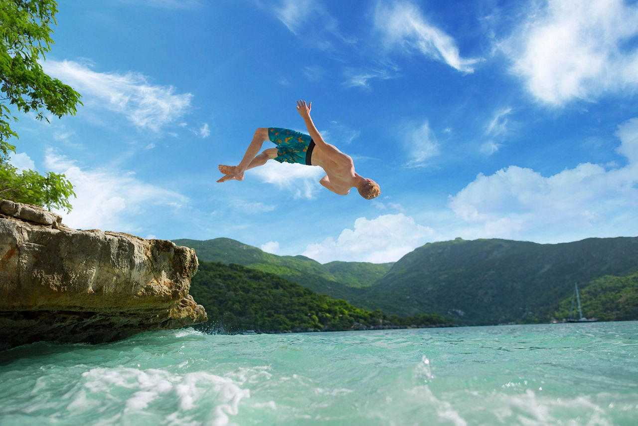 Man Jumping into Ocean in Jamaica
