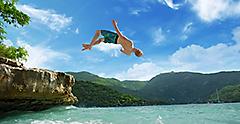 Man Jumping into Ocean in Jamaica