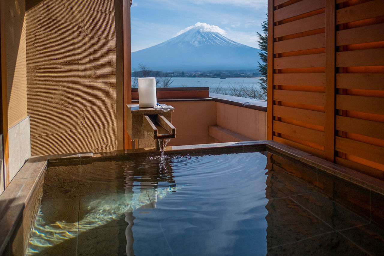 Outdoor hot spring with view of Mountain Fuji and Lake Kawaguchiko. Japan
