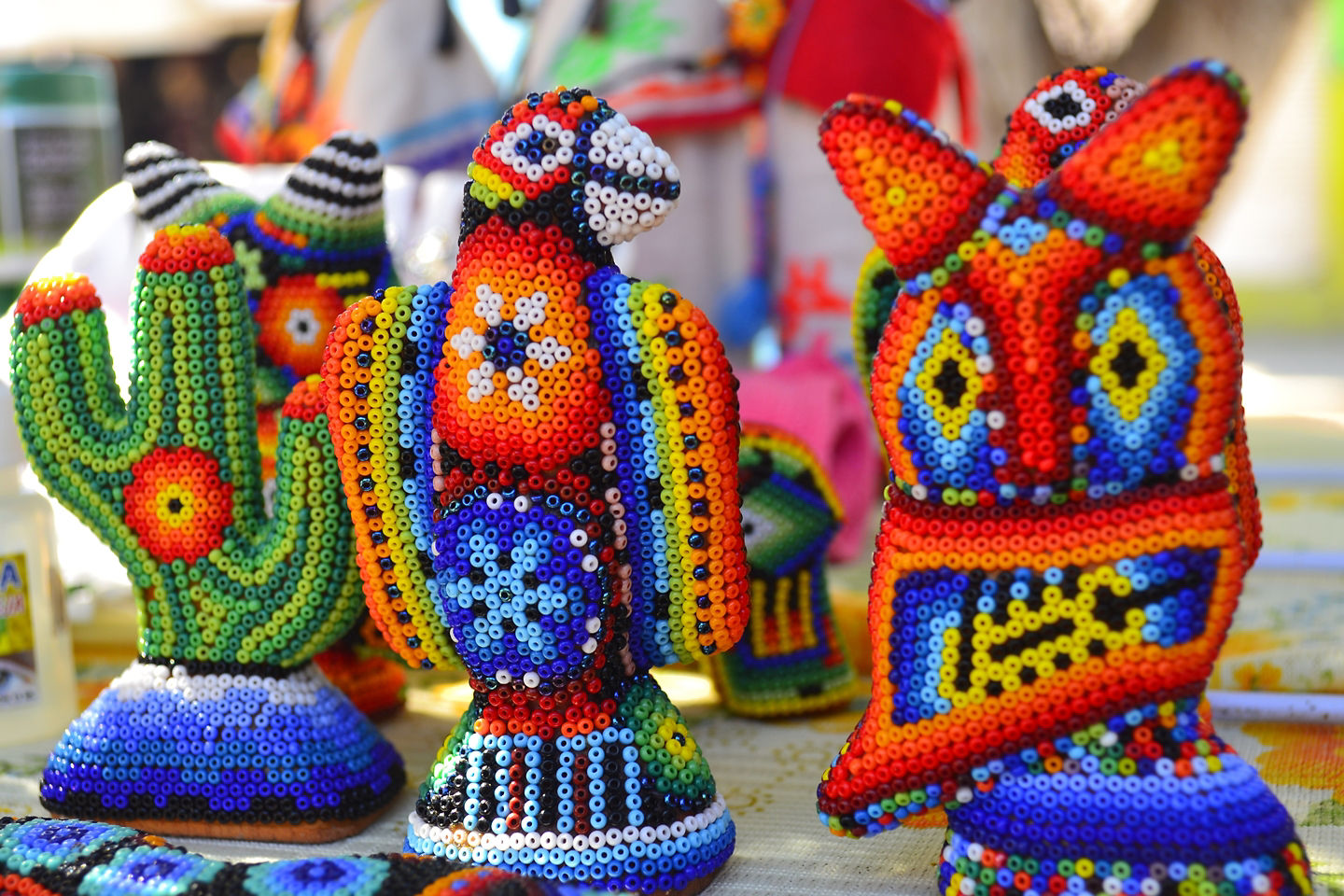 Huichol art features intricate beadwork depicting mythology and vibrant indigenous craftsmanship. - Puerto Vallarta, Mexico