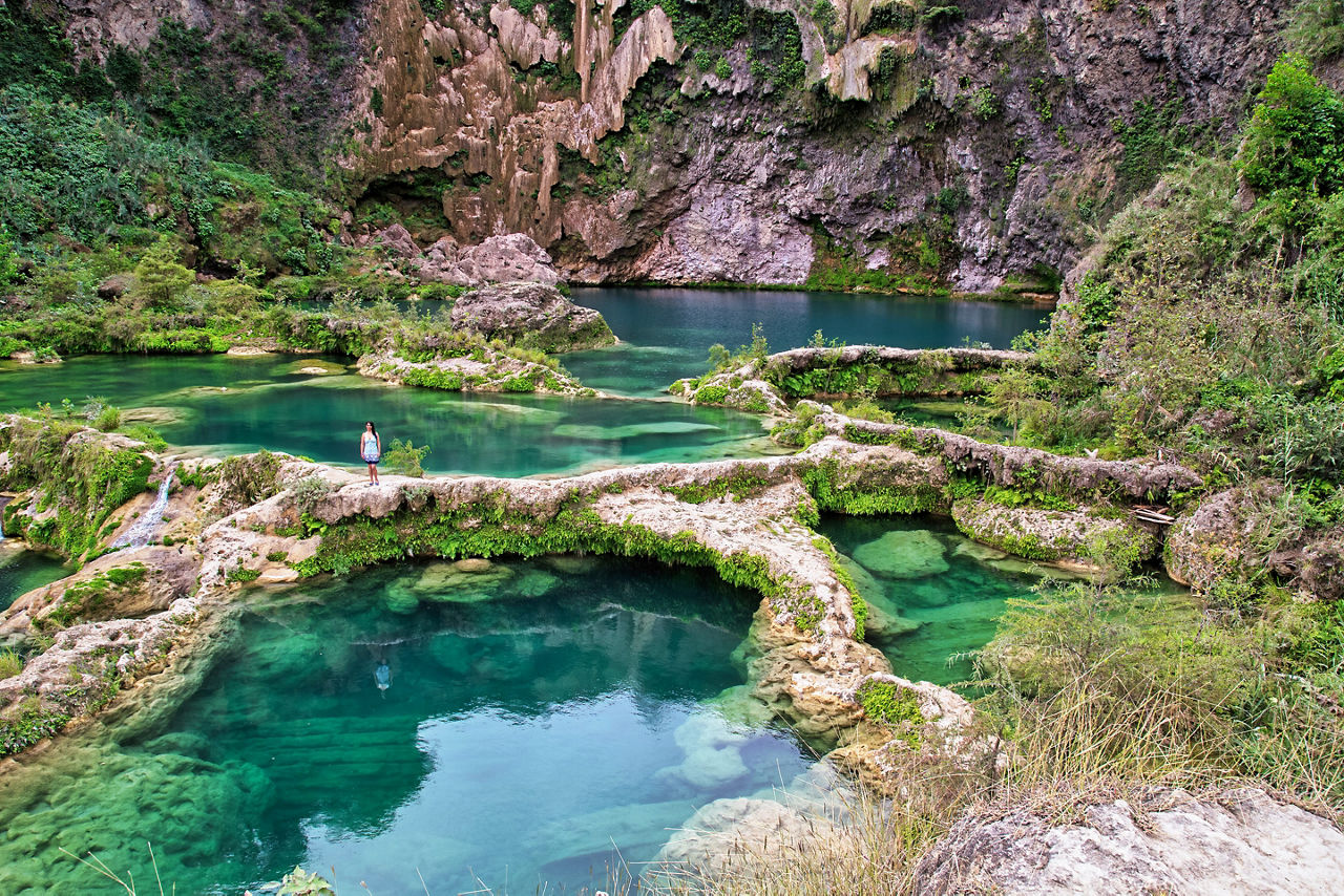 El Salto waterfall dropping into the natural set of turquoise water pools in Huasteca Potosina. Mexico.