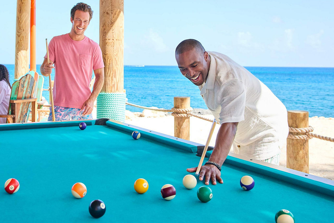 Friends playing pool at beach side