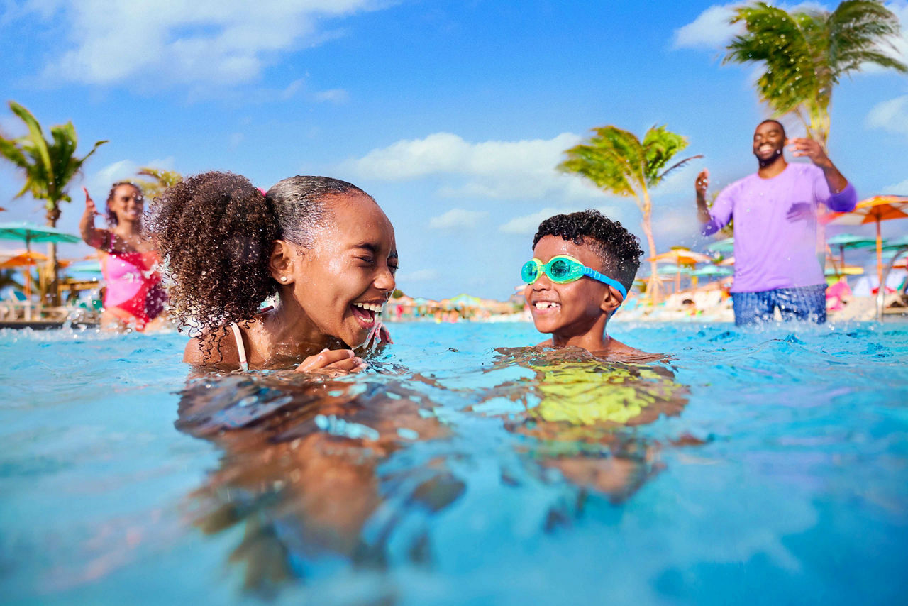 Family playing and swimming in the Chill Beach Shallow End Pool at Royal Beach Club Paradise Island