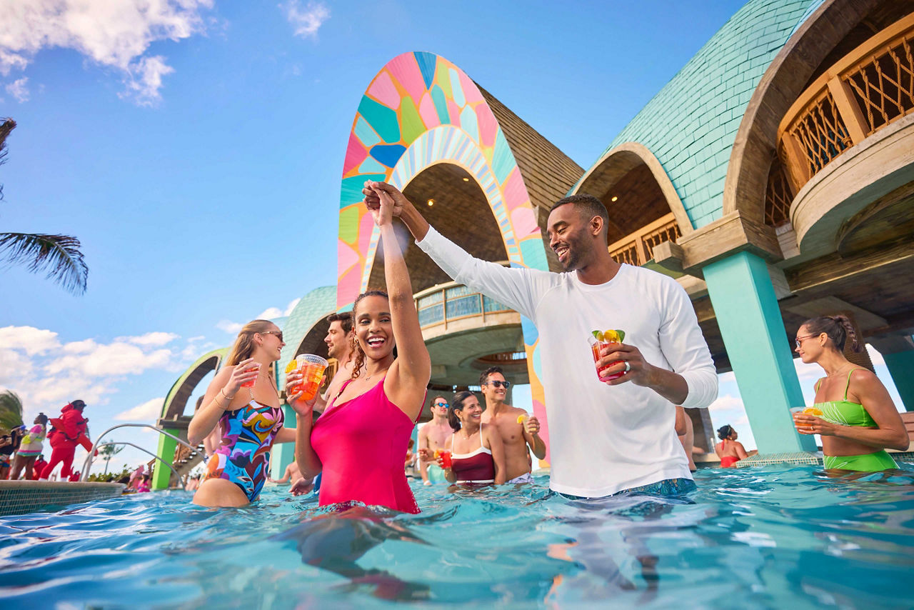 Group of friends drinking at the Party Cove pool at Royal Beach Club Paradise Island