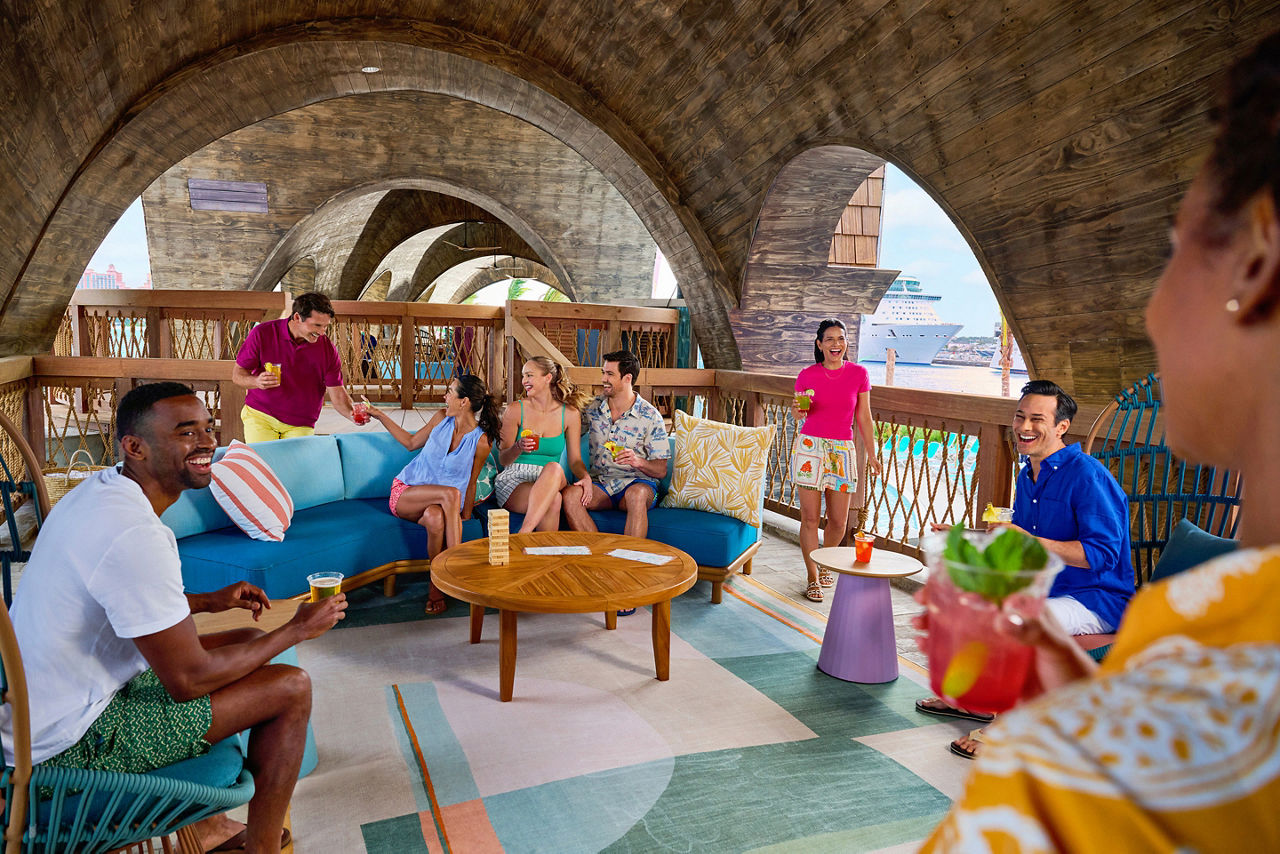 Group of friends drinking at the Party Cove VIP Party Deck at Royal Beach Club Paradise Island. 