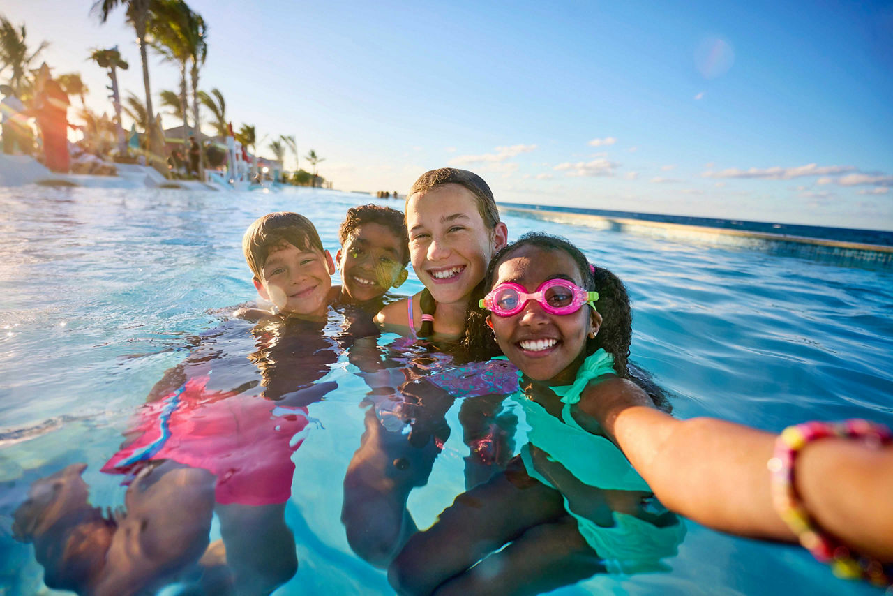 Kids taking selfie at the deep end pool at Paradise Beach at Royal Beach Club Paradise Island