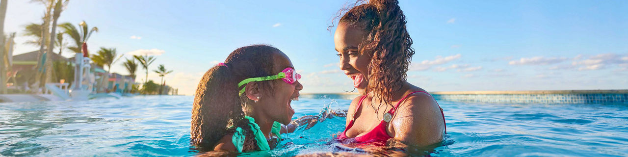 Mom and daughter swimming in the Deep End Pool at Paradise Beach at Royal Beach Club Paradise Island