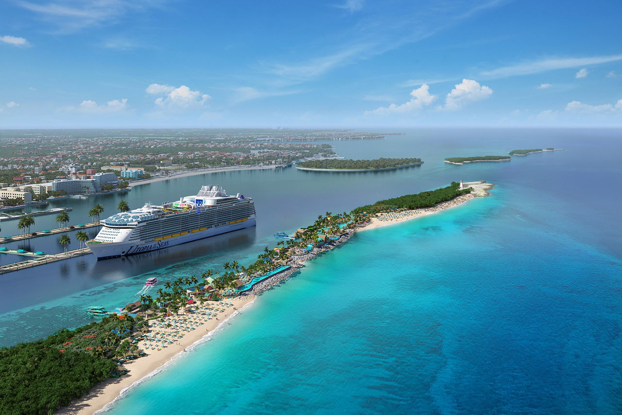 Wide aerial shot of RBC Paradise Island's long stretch of beach with the cruise ship docked near