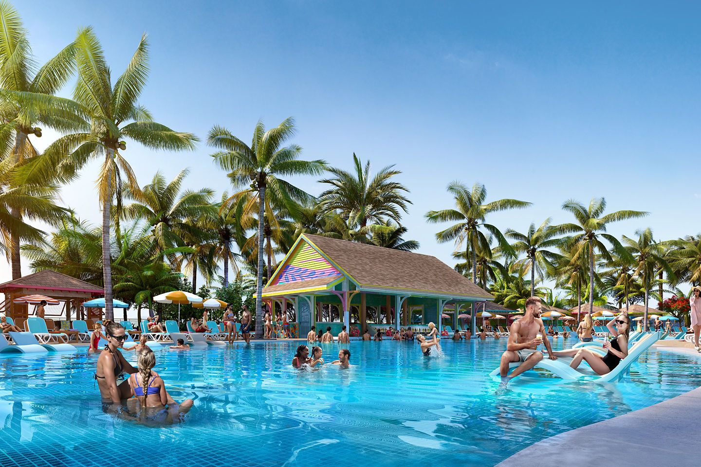 Families relax beside a sparkling pool at Paradise Island’s Royal Beach Club under sunny skies. - Nassau, Bahamas