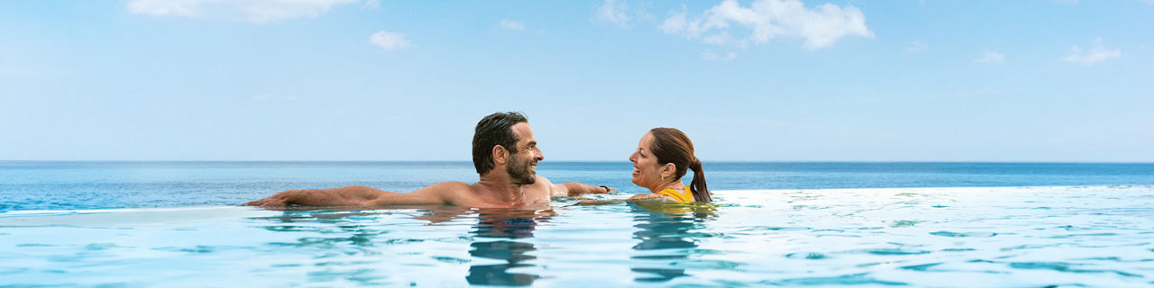 RBC Paradise Island, couple submerged neck deep in the pool