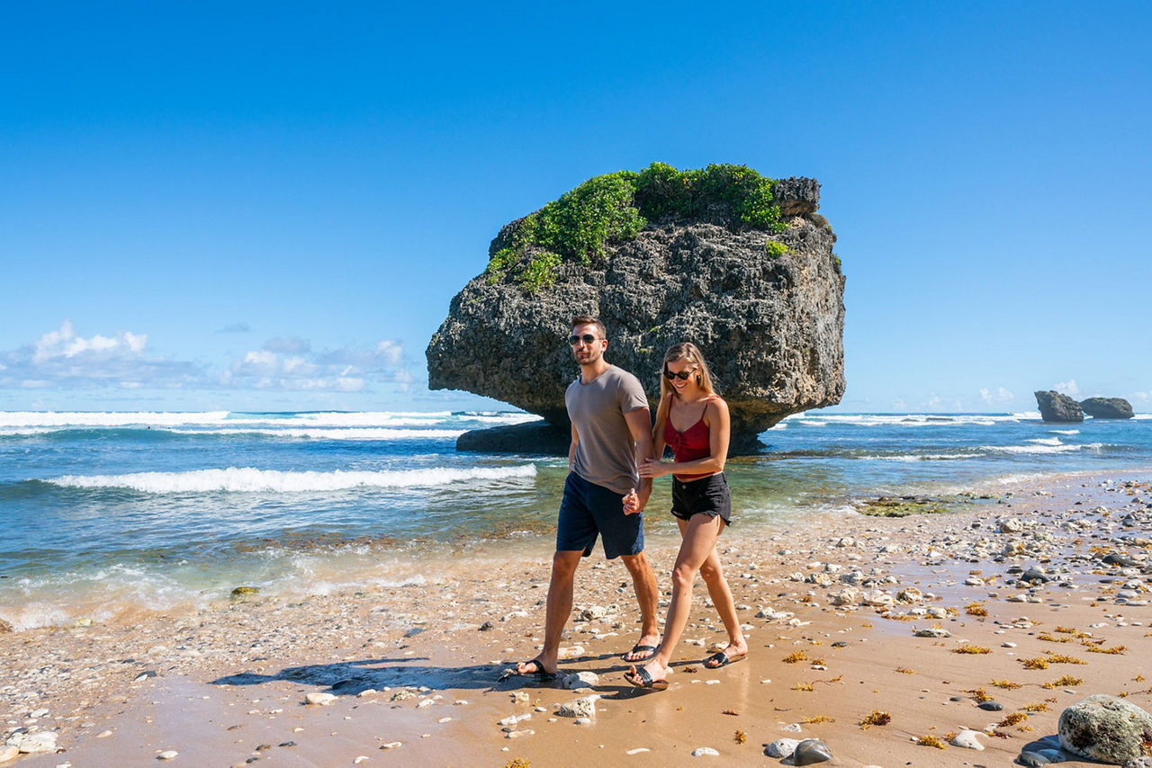 Barbados Couple Strolling by Rock Formation