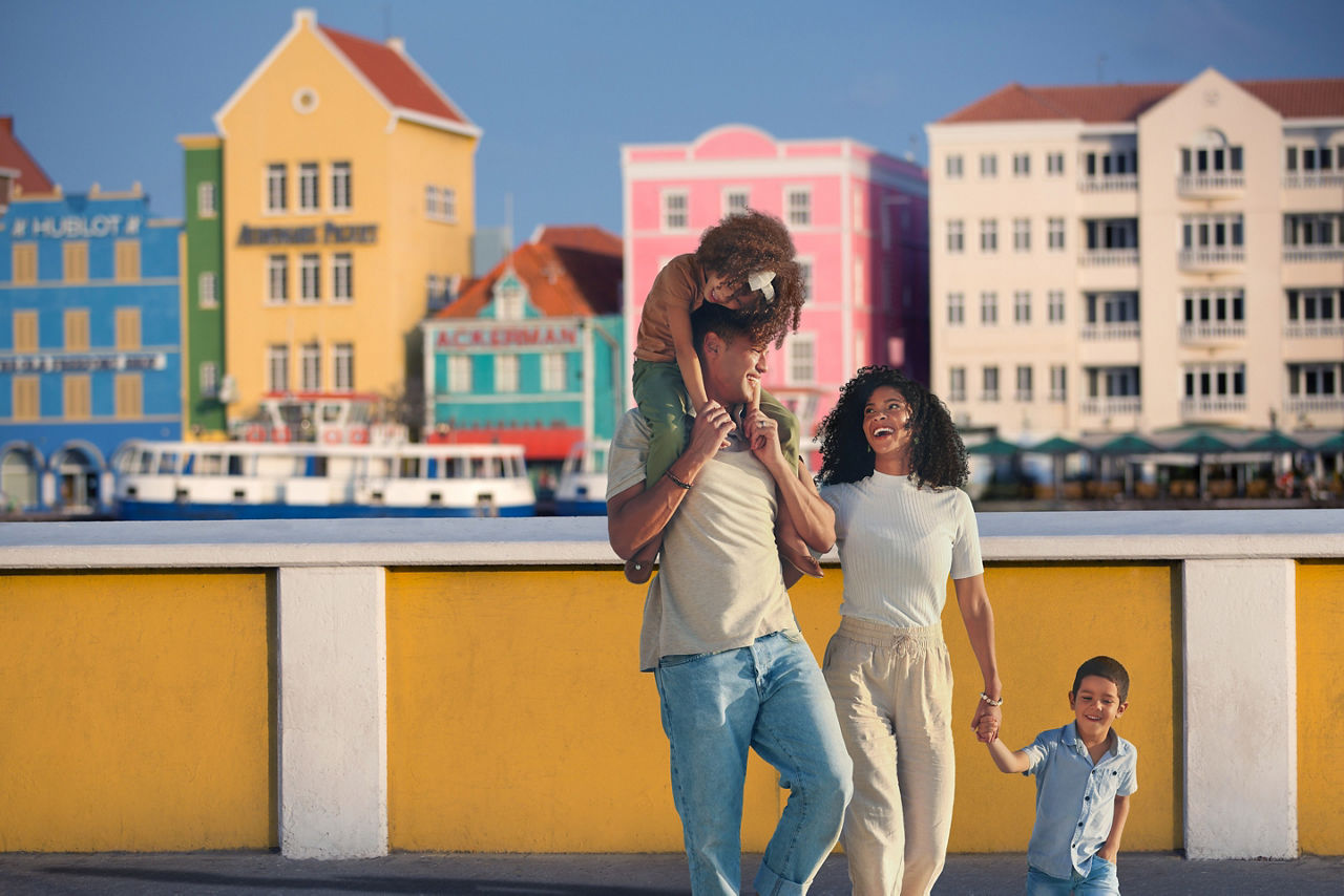 Family walking and holding hands in Willemstand Curacao