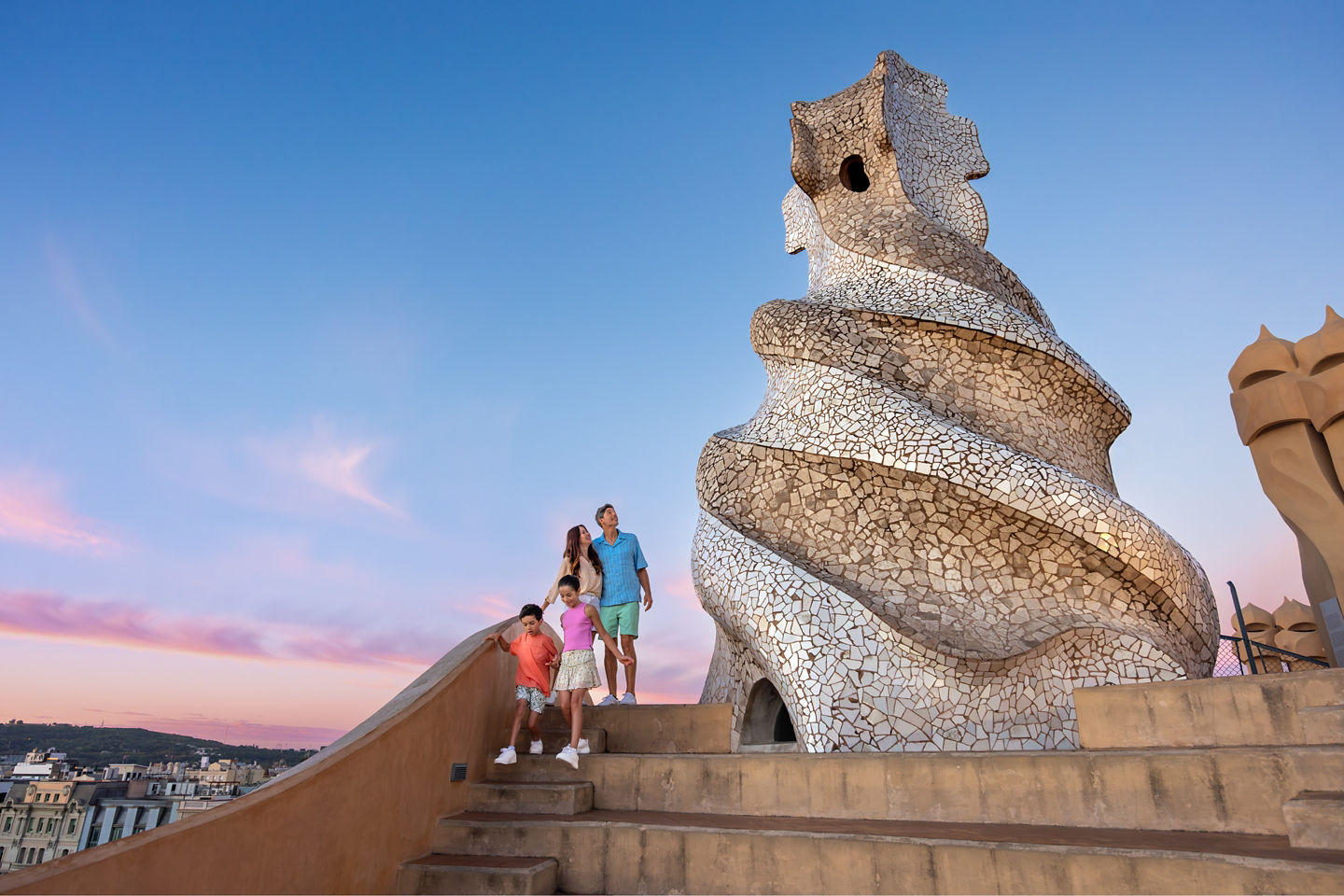 A family walks the curving stone steps of Casa Milà. - Barcelona, Spain