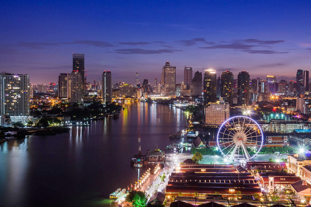 View of the city and the Chao Phraya River at night fall in Bangkok, Thailand
