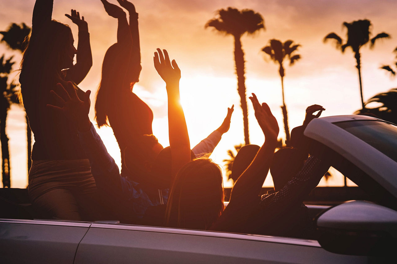 Friends Riding in a Convertible Car during Sunset on a Weekend Getaway in Los Angeles.