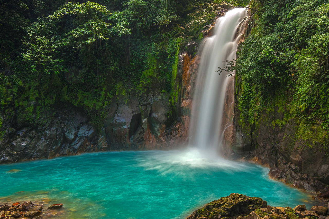 See the sky blue waters at the base of Rio Celeste Waterfall for yourself