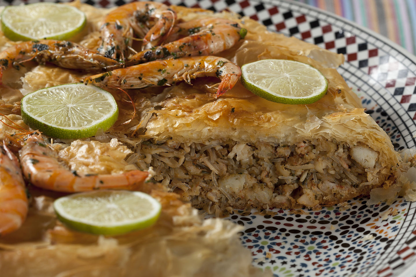 A golden Moroccan seafood pastilla sits layered and crisp, filled with spiced seafood and herbs. - Morocco 