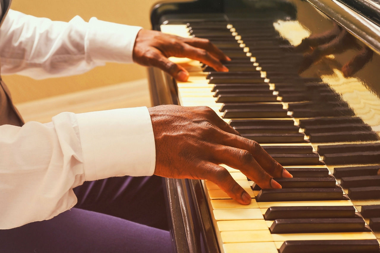 A close up of a man playing the piano