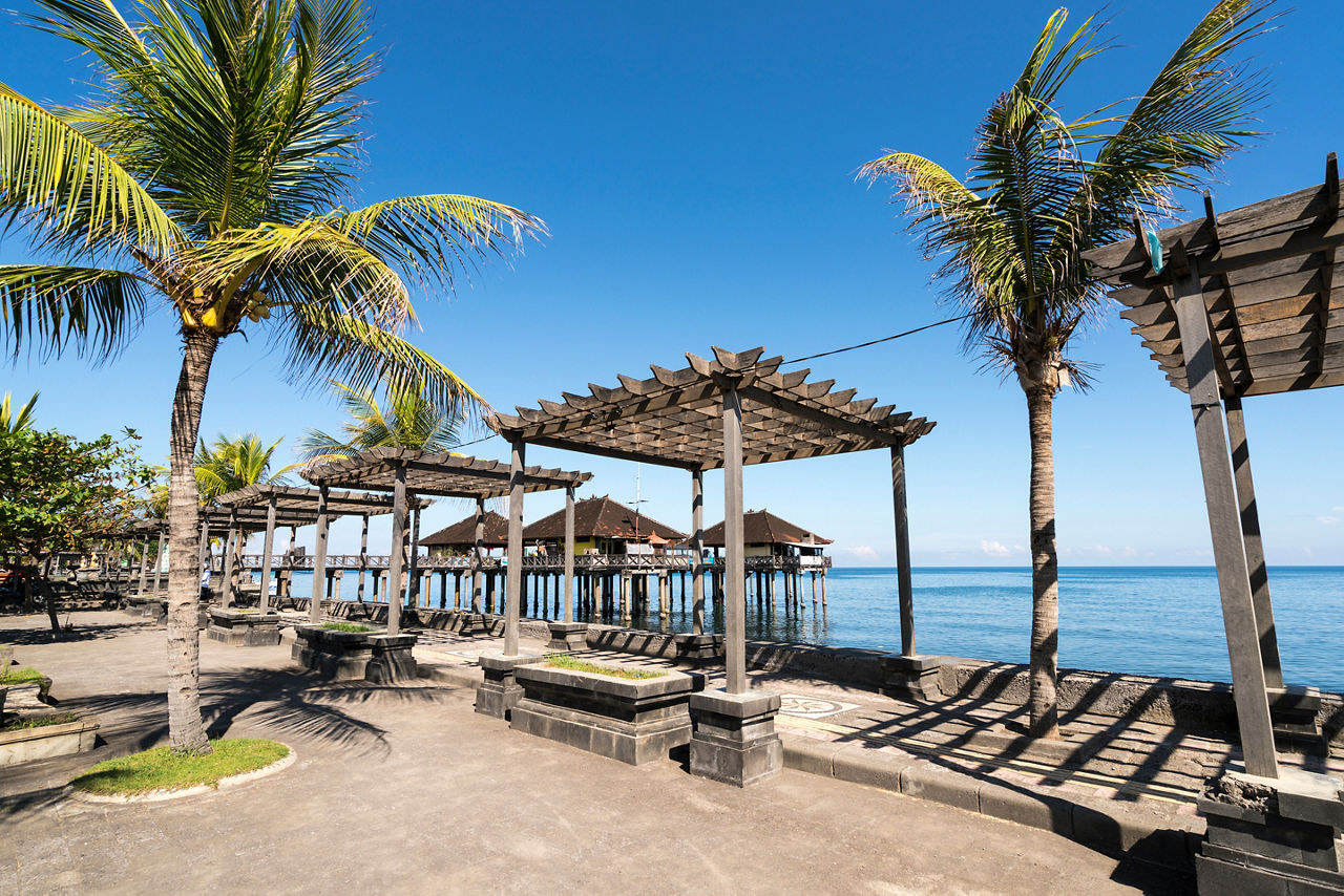Traditional Balinese stilt houses in the sea at the old harbor, Singaraja, Bali, Indonesia
