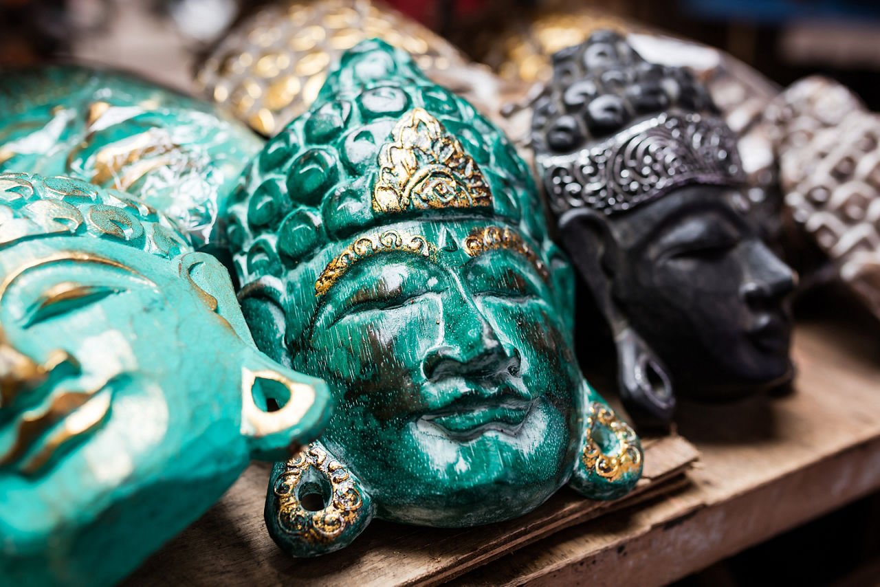Traditional ancient mask souvenirs and handicrafts of Bali at the famous Ubud Market.