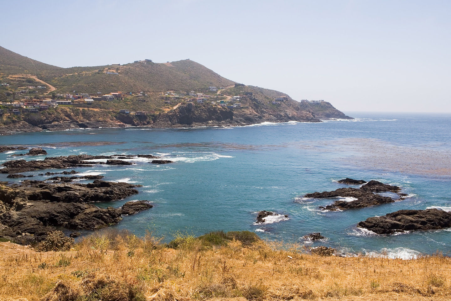 Ocean waves crashing against rocky cliffs. - Ensenada, Mexico