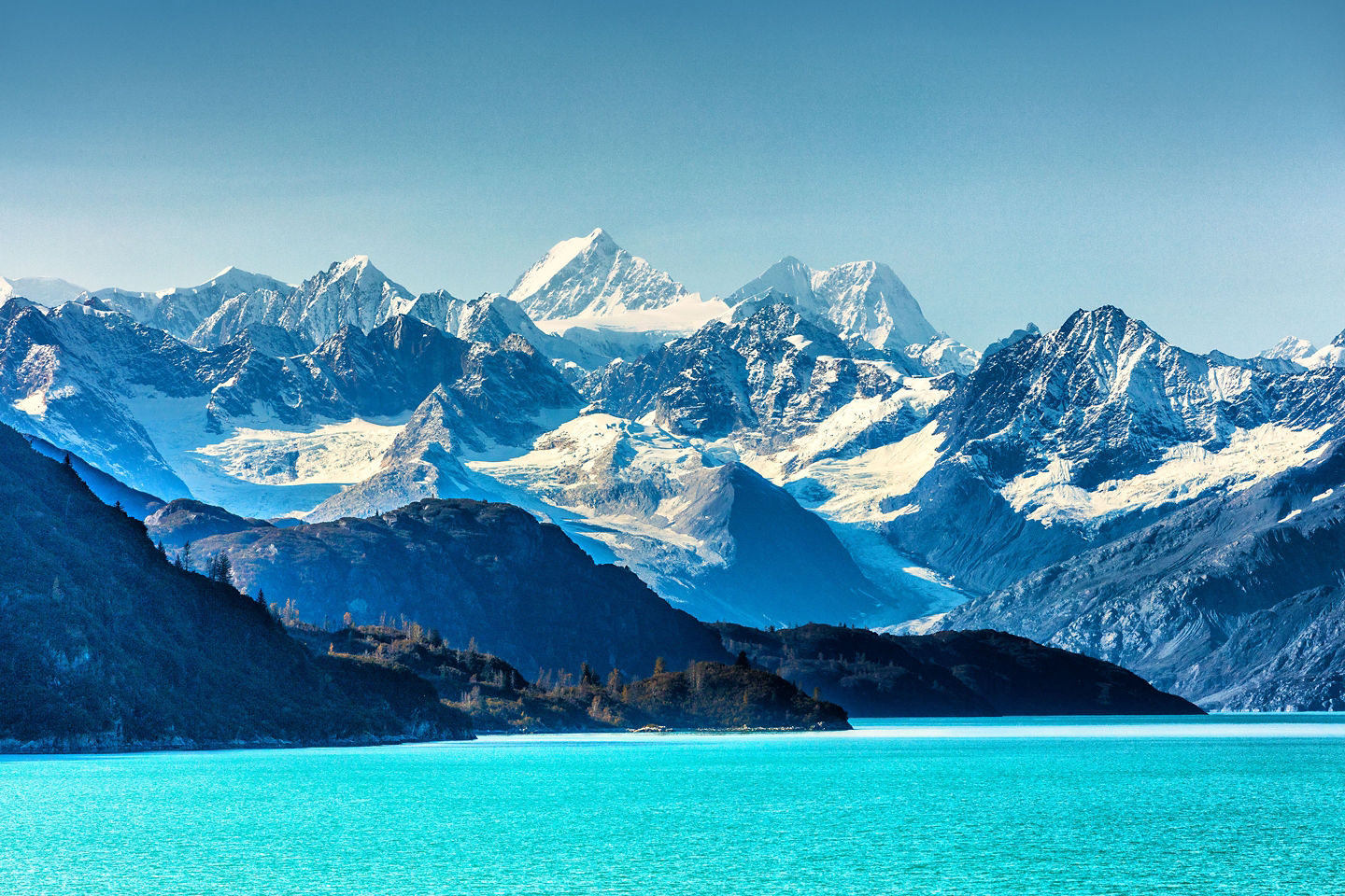Sunlit Glacier Bay framed by rugged peaks and blue ice. - Glacier Bay National Park, Alaska