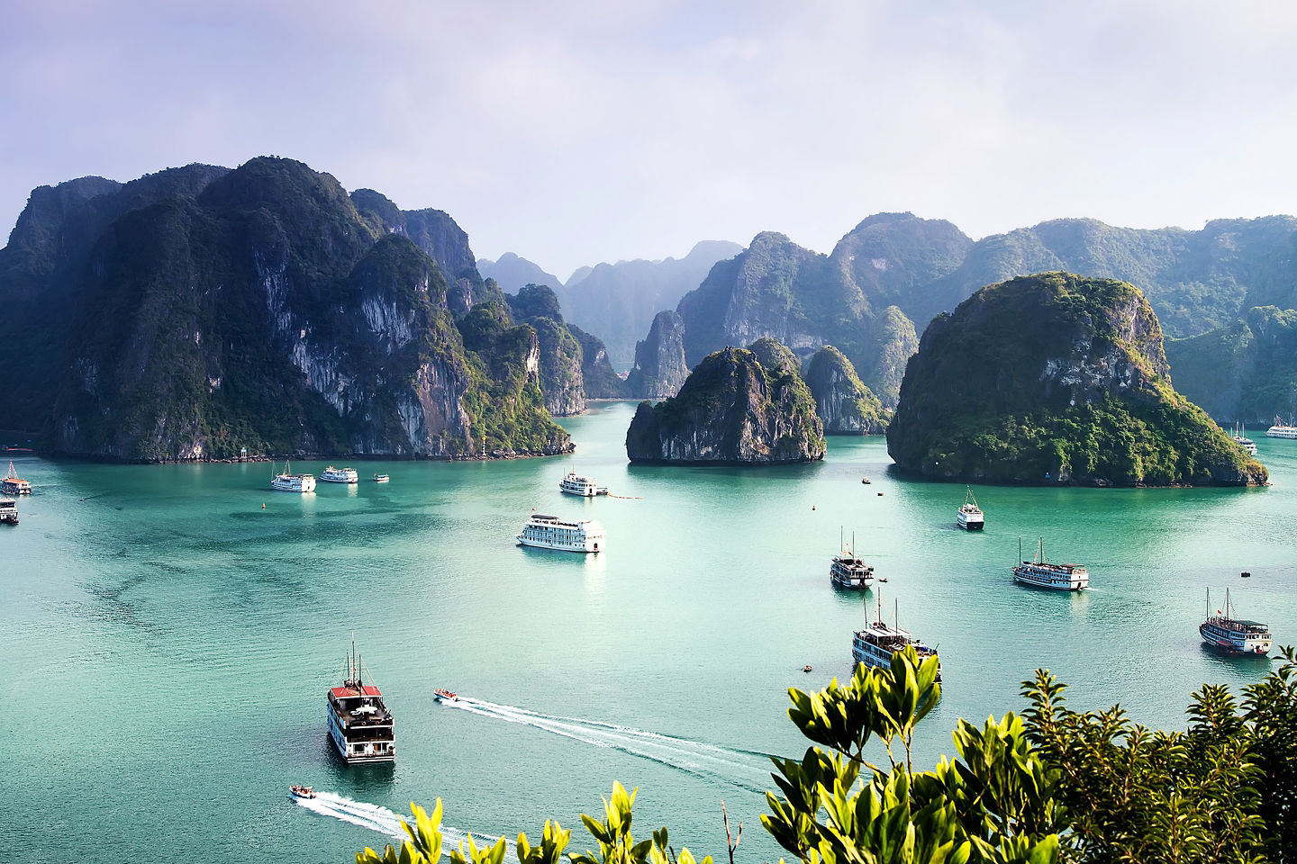Towering limestone karsts rise from emerald waters, defining Ha Long Bay’s beauty. - Ha Long Bay, Vietnam