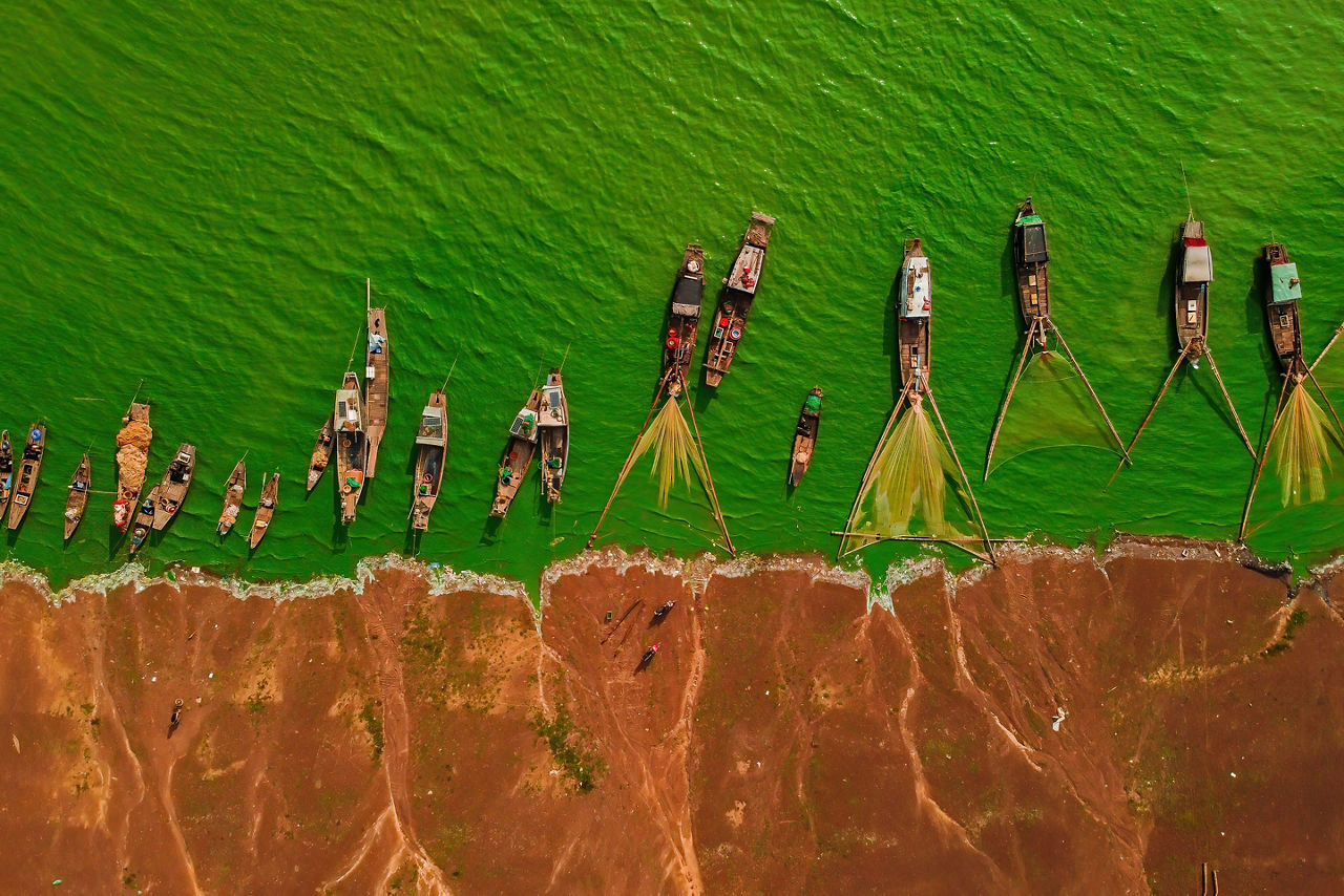 Traditional fishing boats line the shoreline of Tri An Lake in Dong Nai Province, offering a glimpse into the local fishing communities and cultural landscapes near Phuoc An.