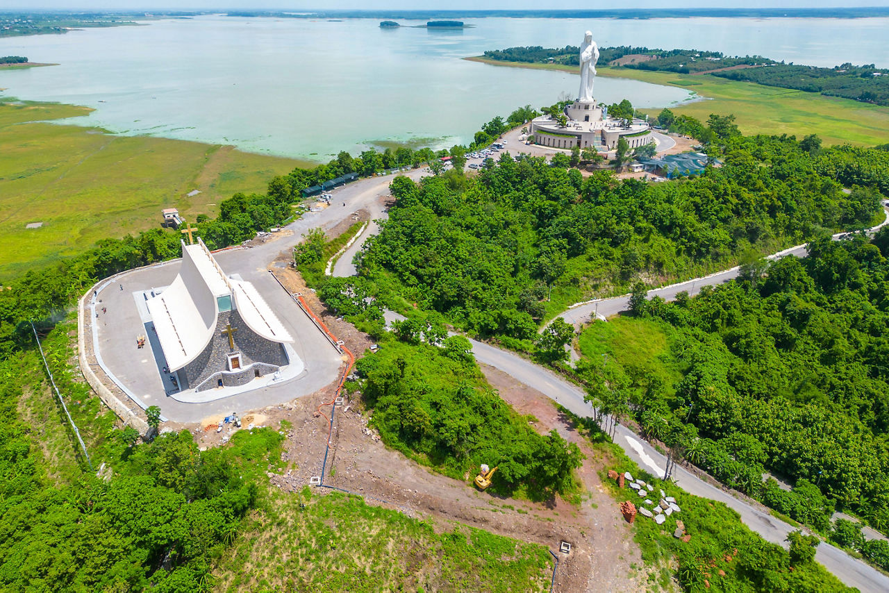 An aerial view showcases the Our Lady of Lourdes statue and surrounding landscapes in Dong Nai Province, a notable cultural landmark near Phuoc An.