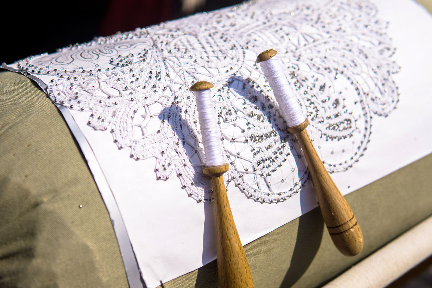 A Slovenian artisan carefully weaves delicate lace by hand, showcasing traditional craft techniques. - Koper, Slovenia