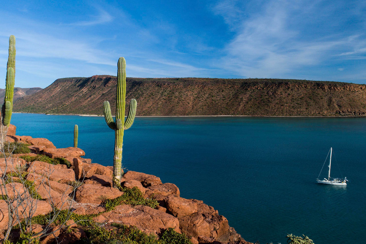 Wide shot of Espiritu Santo Island, yacht sailing, Baja California Sur, Mexico