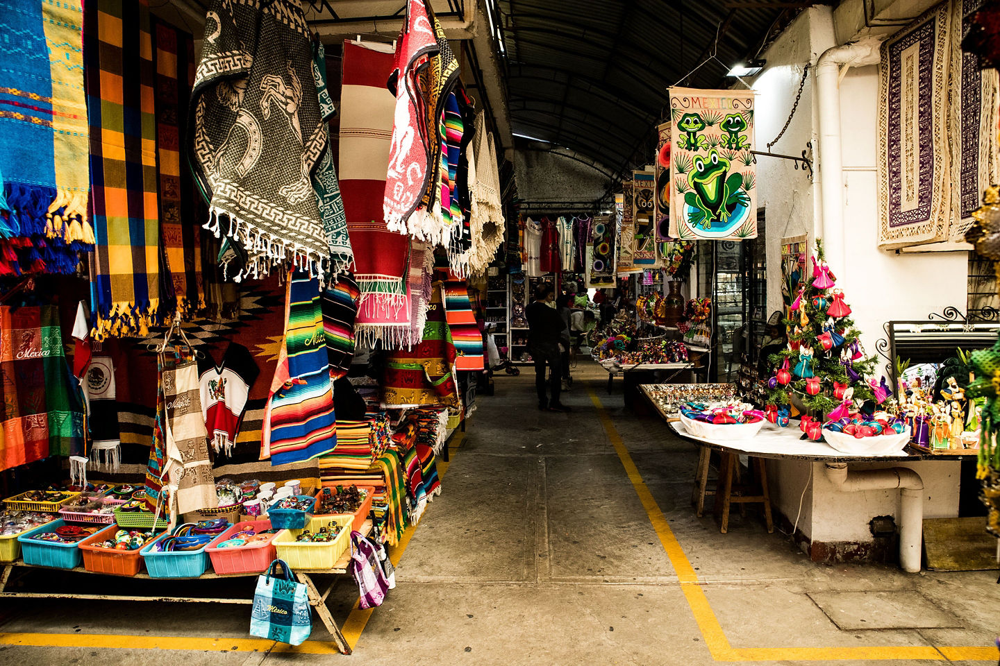 Traditional marketplace showcasing handwoven textiles. - La Paz, Mexico