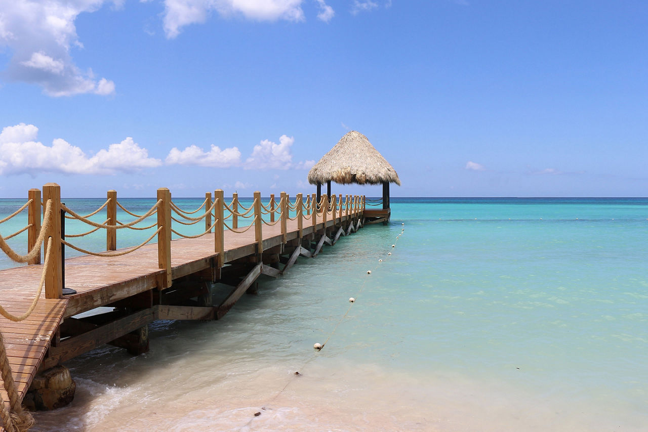Wooden dock and shore at Bayahibe beach