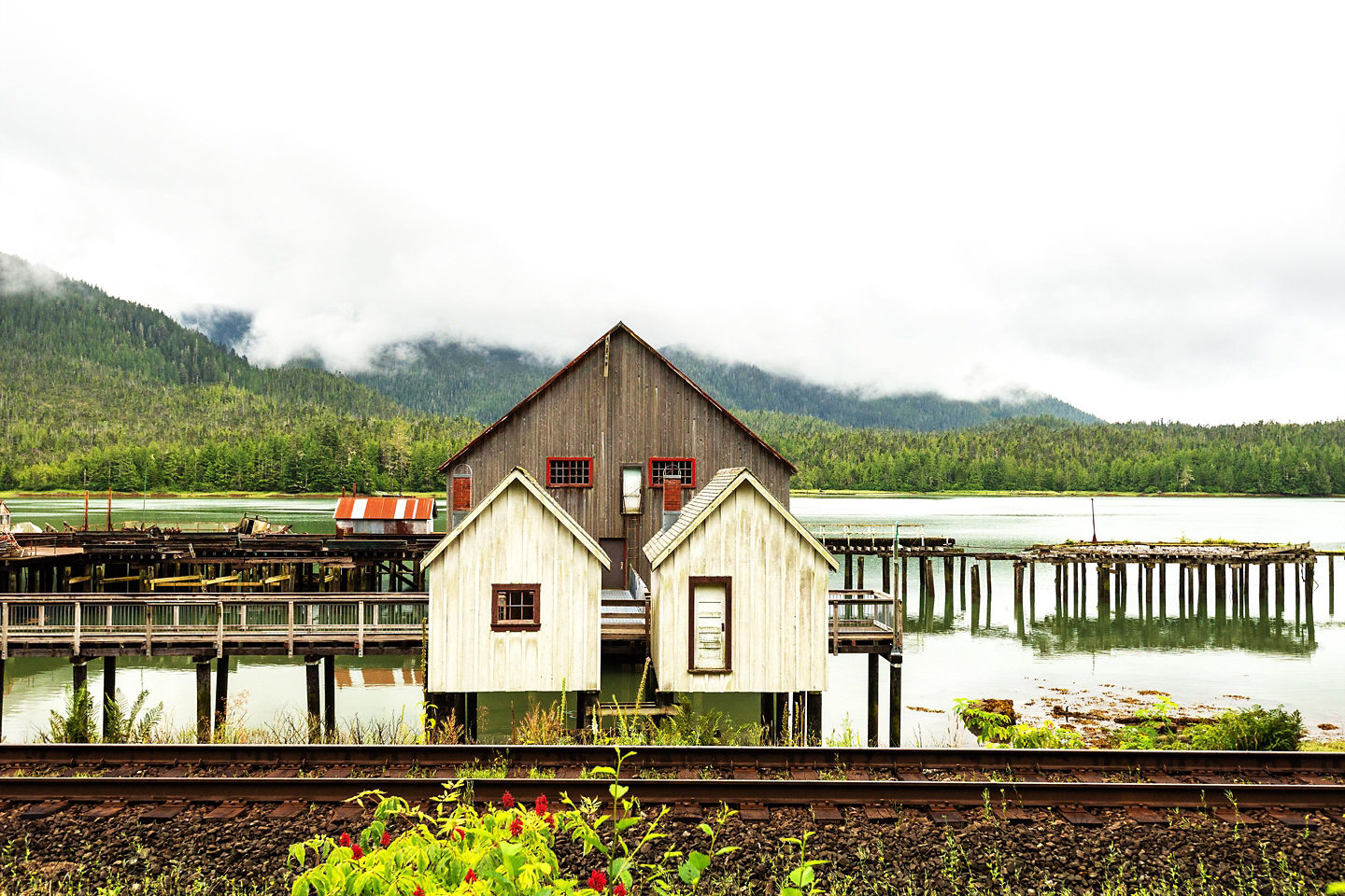 Historic cannery buildings overlook calm water at Prince Rupert’s shoreline. - Prince Rupert, British Columbia