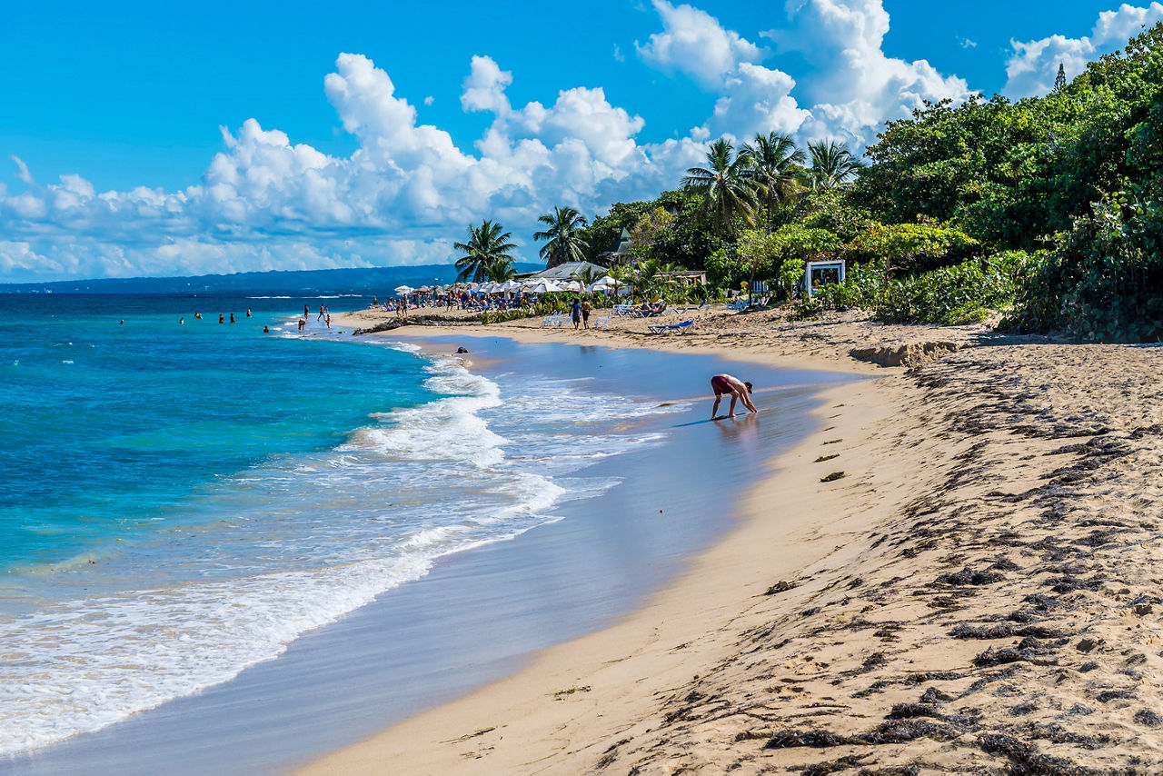 A view along a beach in Puerto Plata in the Dominion Republic on a bright sunny day