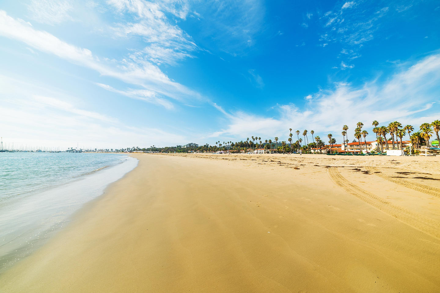 Santa Barbara shoreline stretching beneath bright sun and rolling waves. - Santa Barbara, California