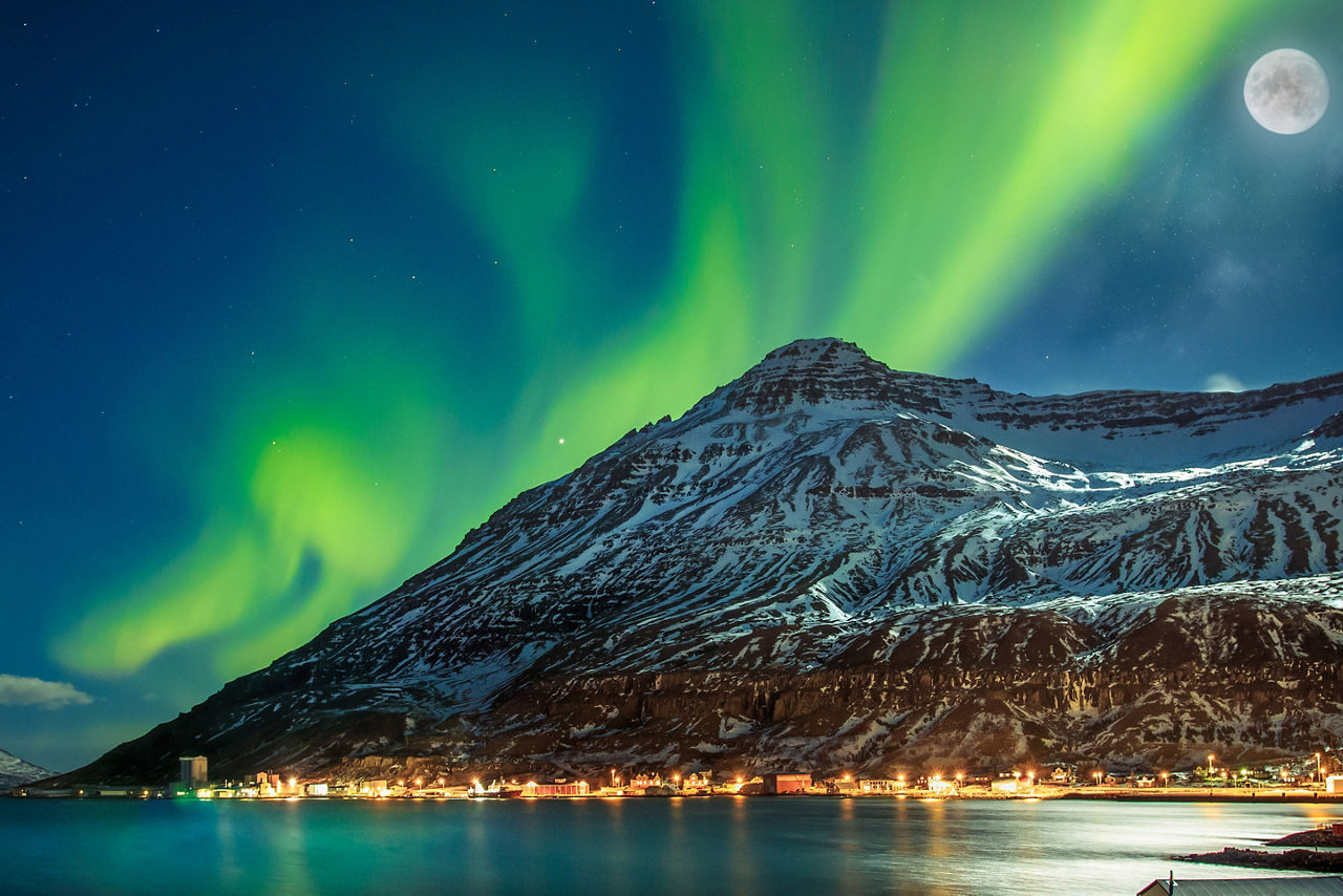 The sky lights up at night over Seydisfjordur. 