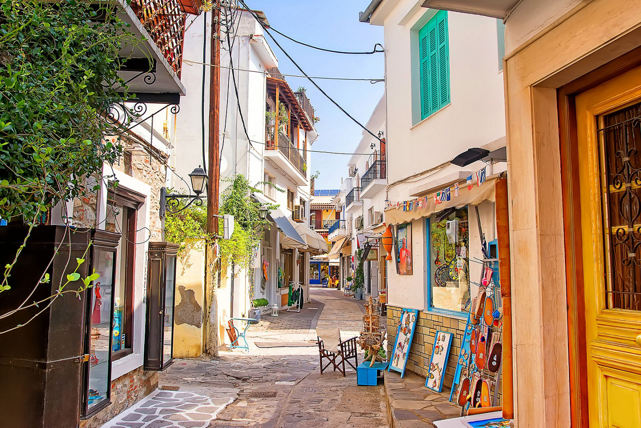 A back street lined with shops in Skiathos, Greece. 