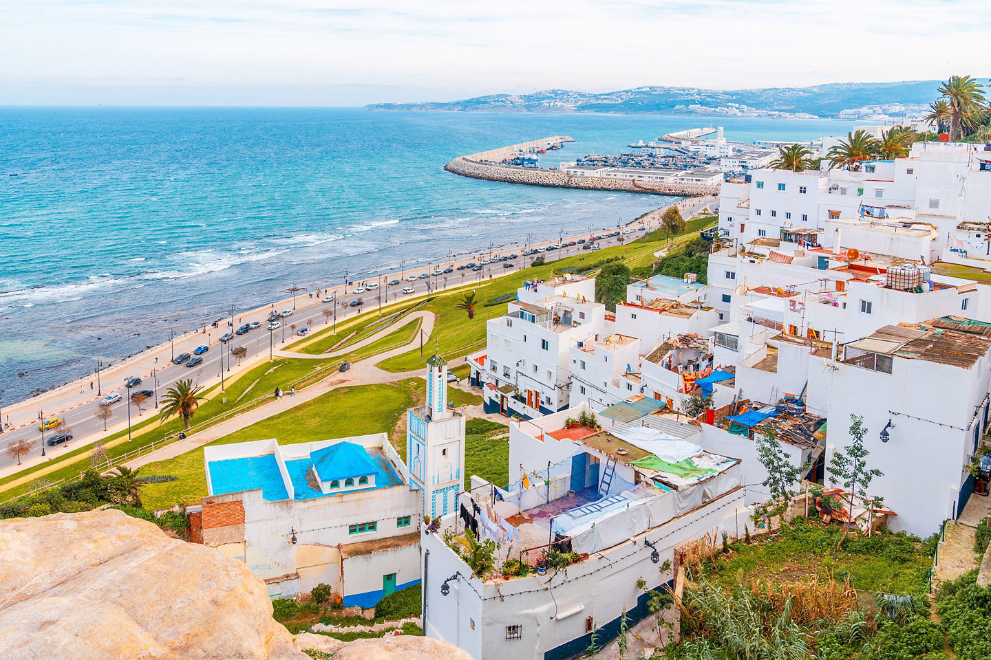 An aerial view of Tangier shows its coastline, port, and cityscape curving along the bay. - Tangier, Morocco