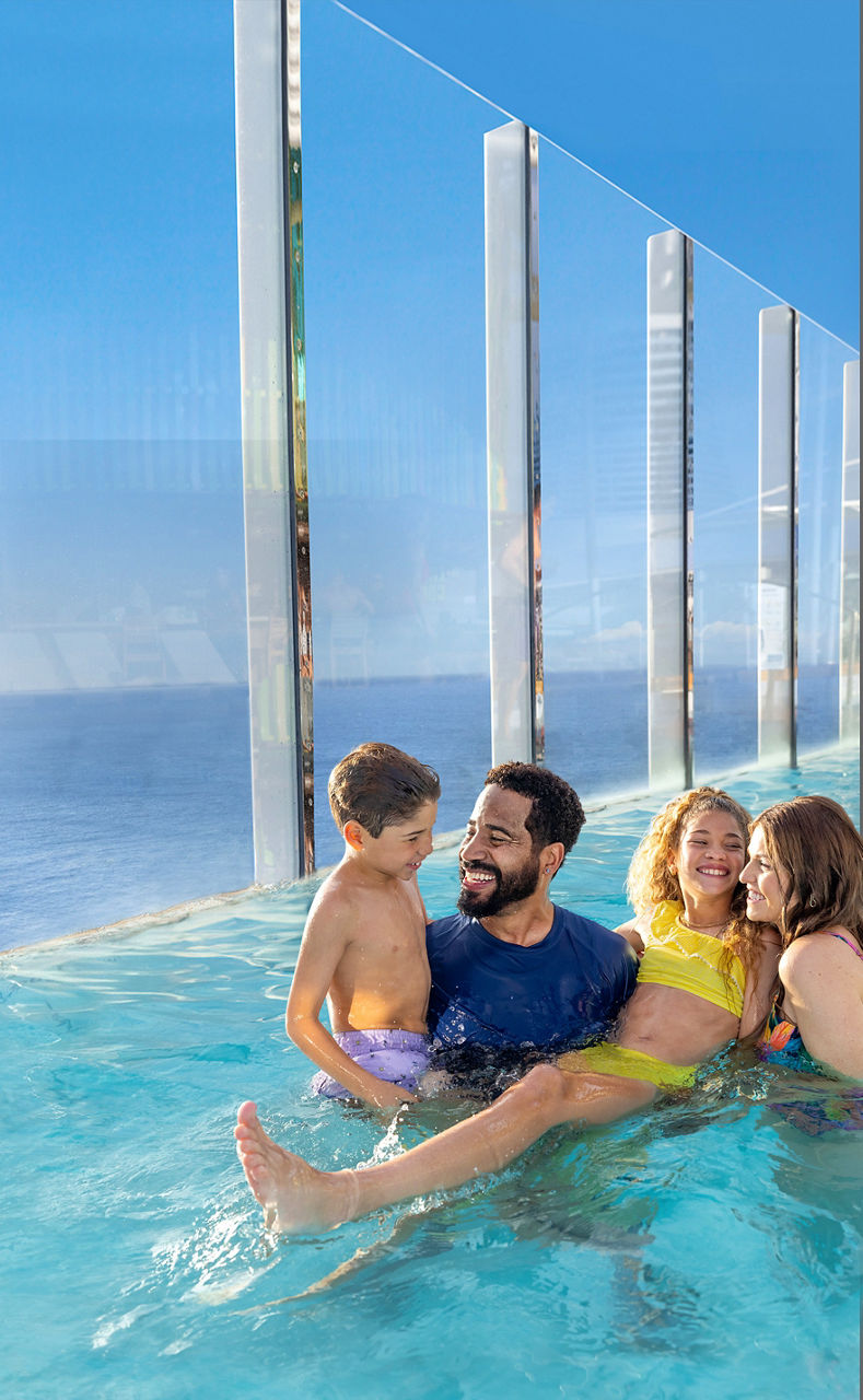 Family of four inside infinity pool