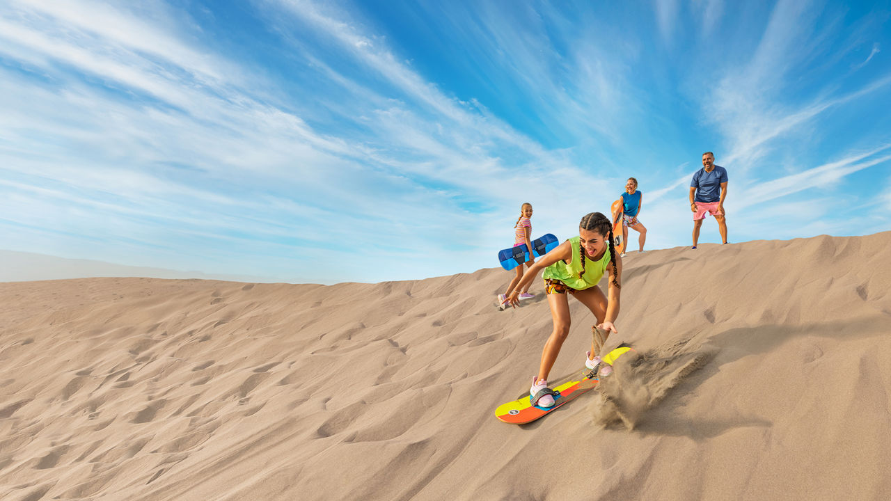 september caribbean cruises deals family having fun sandboarding at the dunes hp jumbotron 1920 1080